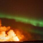Iceland: Northern Lights captured glowing over erupting volcano